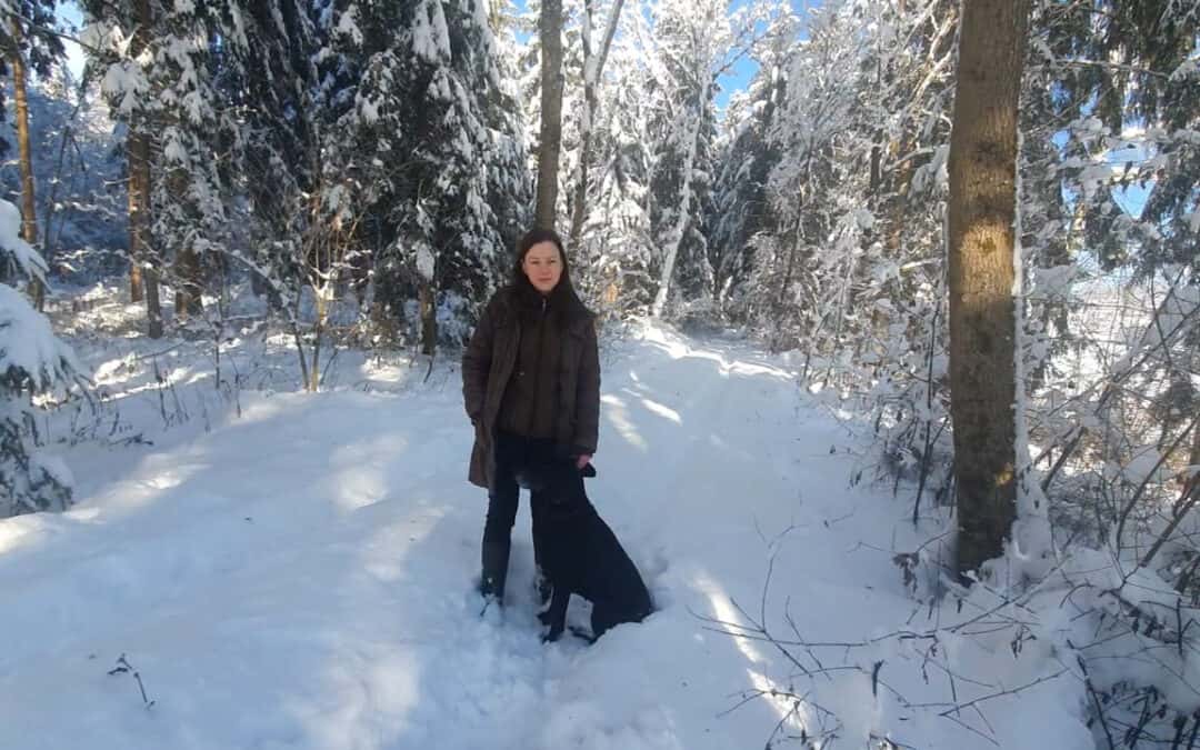Elisabeth genießt die Winterlandschaft mit ihrem Hund an der Leine